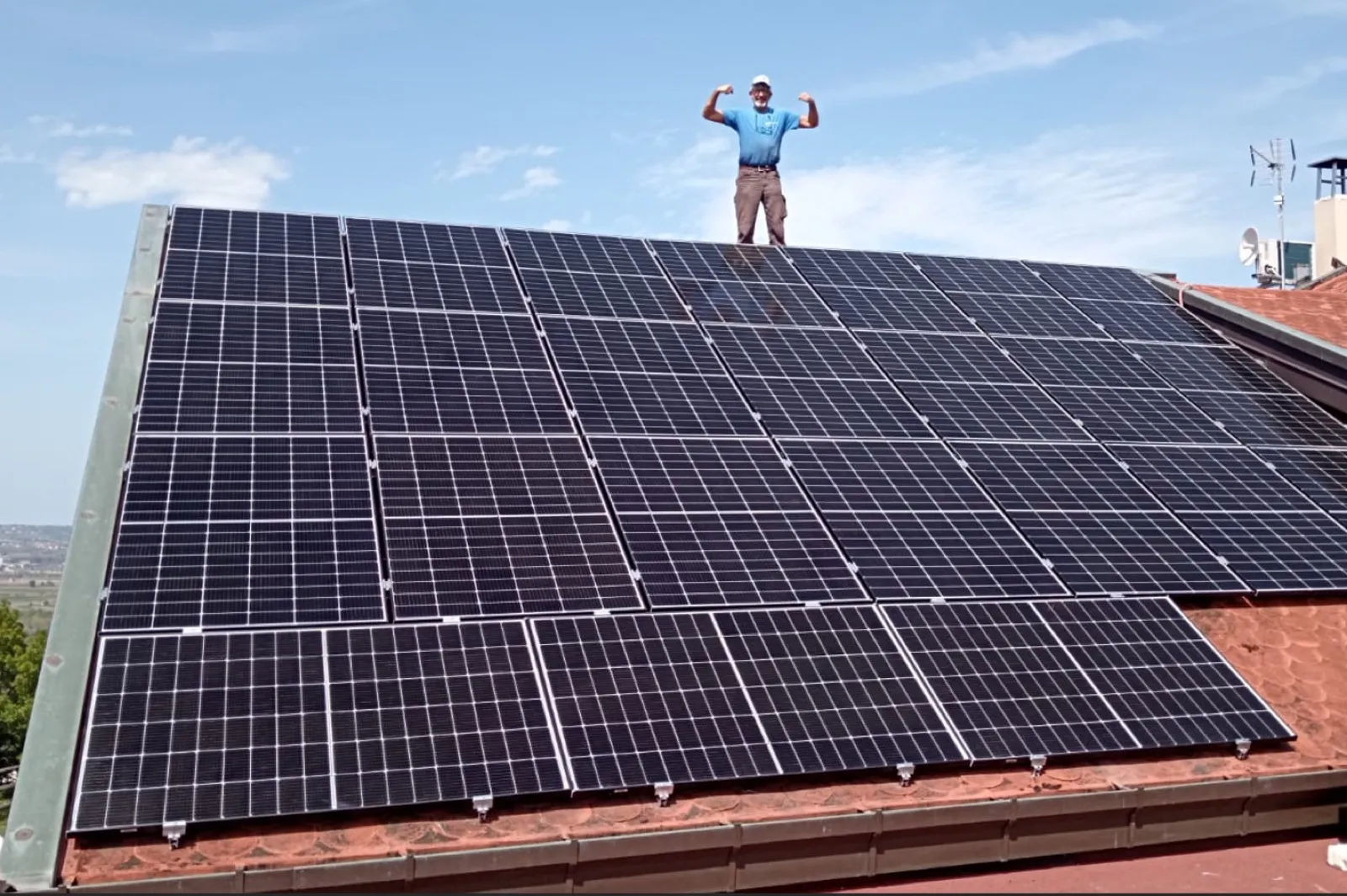 New Energy technician installing a solar system on a residential roof