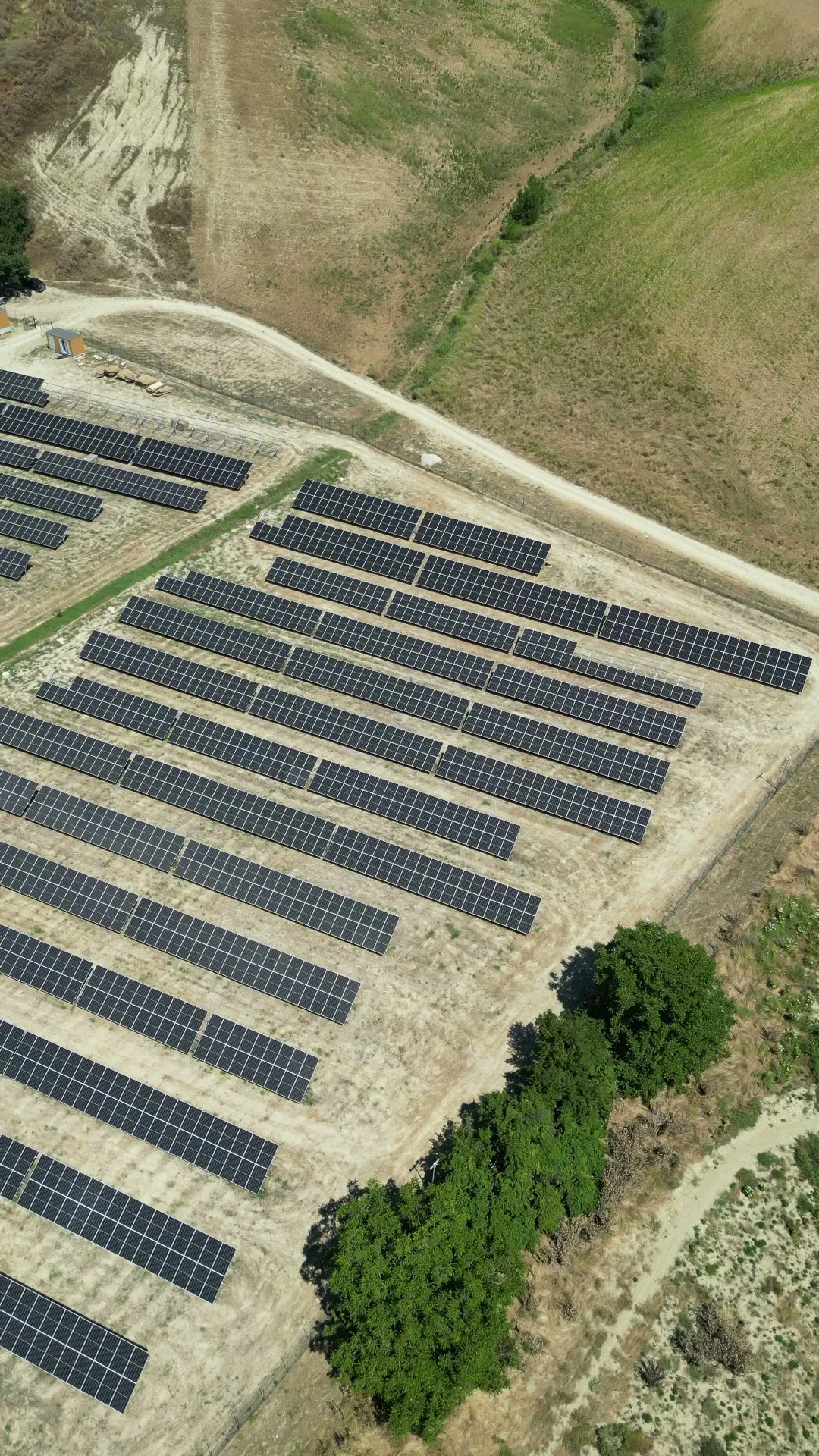 Ground-mounted solar farm among the hills, drone view