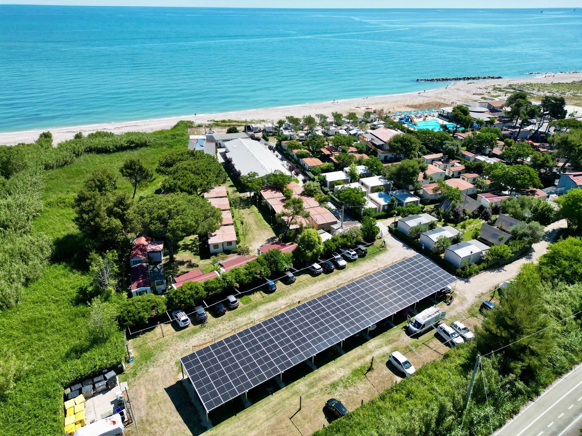 Seaside holiday village with a solar carport, drone view